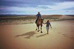 Off for a camel ride in the Mongolian desert. Photo credit: Michel Behar