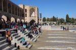Khaju Bridge, one of Isfahan's iconic bridges, filled with locals celebrating the flowing water.