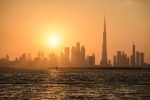 Dubai backlit by a blazing sunset as seen from Dubai Creek, UAE. Photo credit: Courtesy of Desert Adventures