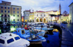Boats crowding the dock of a Balkan city. Photo credit: Peter Guttman