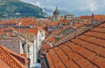 Hikers along the wall walkway are surrounded by Dubrovnik's famous terracotta red-tiled roofs. Photo credit: Lisa Peterson