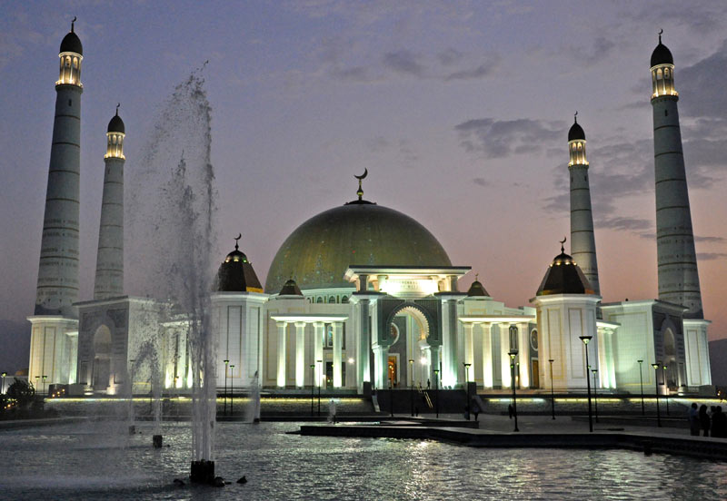 The Kipchak Mosque glows at sunset in Ashgabat, Turkmenistan