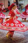 Swirling scarlet dancers with embroidered motifs in Uzbekistan. Photo credit: Suresh Mehta