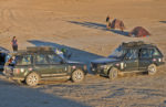 Camping with Land Rovers at Darvaza Gas Crater, in the desert of Turkmenistan. Photo credit: Russ Cmolik & Ellen Cmolik