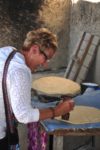 A MIR traveler learns how to bake bread in Uzbekistan. Photo credit: Russ Cmolik & Ellen Cmolik