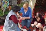 A MIR traveler learns how to make a traditional felt rug in Kyrgyzstan. Photo credit: Russ Cmolik & Ellen Cmolik