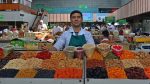 A friendly face greets shoppers in Almaty’s Green (Zelyony) Bazaar. Photo credit: Bill Thornton