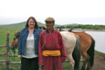 A MIR client poses with a Mongolian rider. Photo credit: Michele Rice