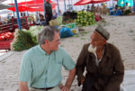 MIR’s founder and president, Douglas Grimes, takes time every year to personally scout our destinations; here, he’s pictured chatting with a local market vendor in Kashgar, China.. Photo credit: Douglas Grimes