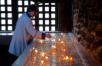 Lighting a candle in an orthodox church. Photo credit: Phil Kidd