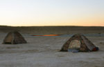 The campfire never goes out for tenters at Turkmenistan's Darvaza Gas Crater. Photo credit: Russ & Ellen Cmolik