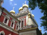 Gold domes above pastel paints at Rila Monastery. Photo credit: Michel Behar