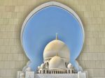 An arch and domes at the Sheikh Zayed Grand Mosque in Abu Dhabi. Photo credit: Michel Behar