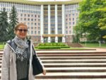 Patricia Schultz, author of 1,000 Places To See Before You Die, in front of the Moldovan Parliament Building in Chisinau, Moldova. Photo credit: Michel Behar