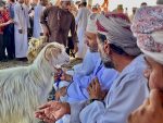 Men and a goat at the Nizwa Friday livestock market
