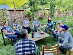 Backyard discussions at a local home in Albania. Photo credit: Michel Behar