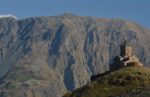 Mountains rising behind the Holy Trinity Church in Kazbegi (Georgia.). Photo credit: Peter Guttman
