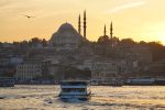Sunset from the Galata Bridge in Istanbul as a ferry passes by. Photo credit: Jake Smith