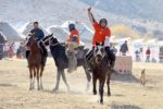 Wear whatever headgear you can find at Kyrgyz horse games. Photo credit: Vlad Ushakov