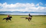 Horses racing in front of high-altitude Song Kul Lake. Photo credit: Max Sjoblom