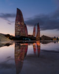 Evening descends on Baku's Flame Towers, reflected in a puddle on Martyrs' Lane. Photo credit: Jered Gorman