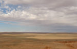 The wide open spaces of Mongolia's Flaming Cliffs are home to dinosaur bones and fossils. Photo credit: Andrew Barron