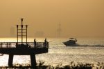 Fishermen at sunset, with the Kuwait Towers in the background. Photo credit: Mohammad Matalkah/Pexels