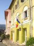 House in Romania with national flag. Photo credit: Liz Tollefson