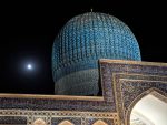 The turquoise dome of the Gur-Emir Mausoleum by night.