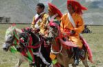 Tibetan men going to festival. Photo credit: Phil Kidd
