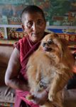 A Tibetan monk and his dog. Photo credit: Phil Kidd