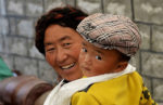 Mother and child in Lhasa, Tibet. Photo credit: Phil Kidd